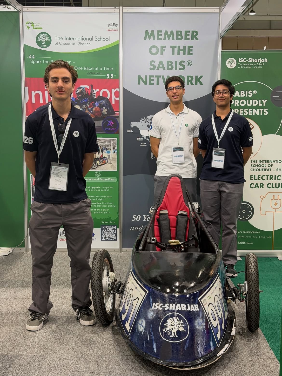 Younes Nader with the VoltStar team and their electric race car at the Evolve Future Mobility Show, Expo Centre Sharjah