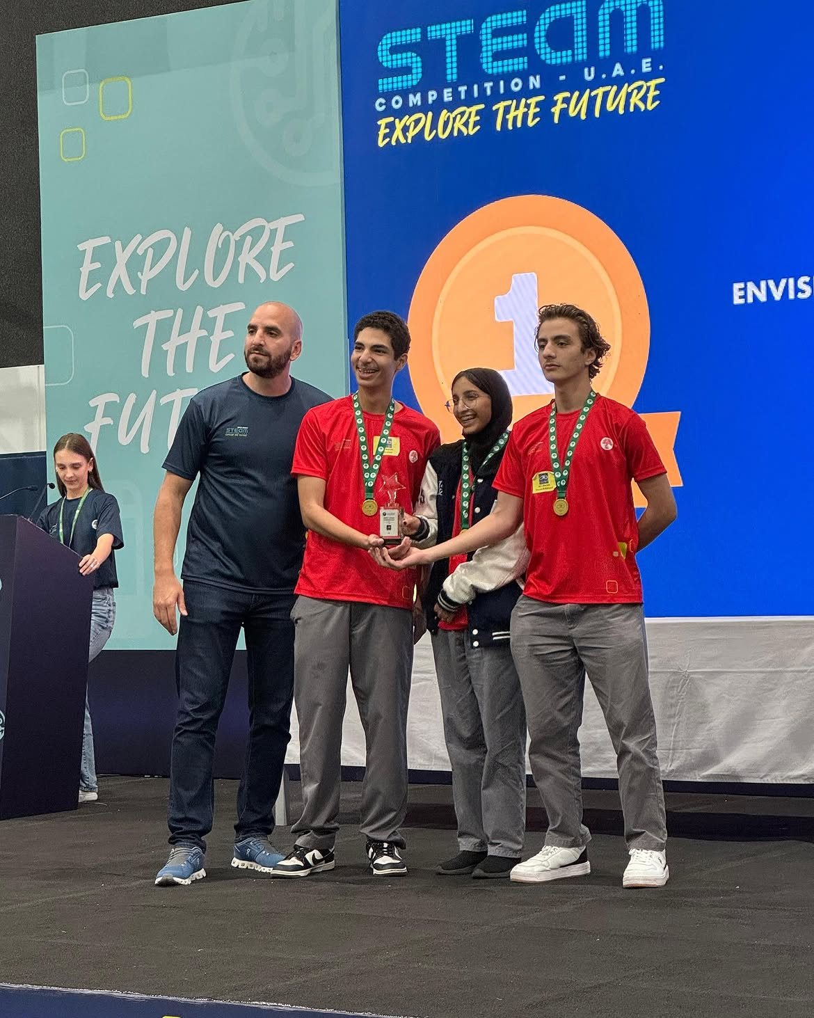 Younes Nader on stage receiving first place with his team at the SABIS STEAM Competition in the UAE